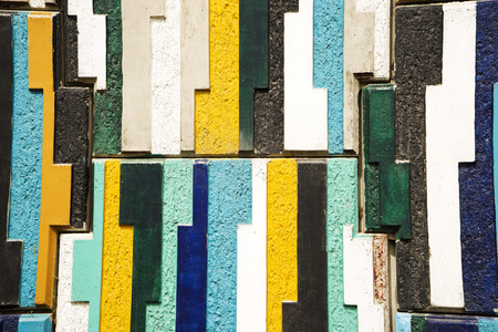 The vertical wall of colored stones , tiles , background