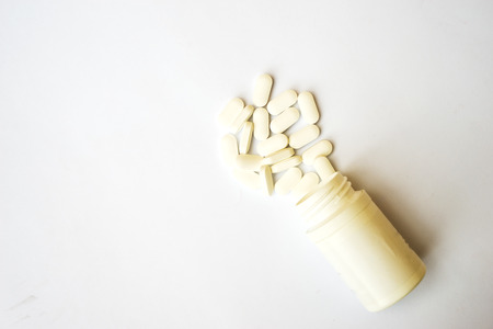 The medicine bottle and drug tablets isolated on white background, medical supplementsの写真素材