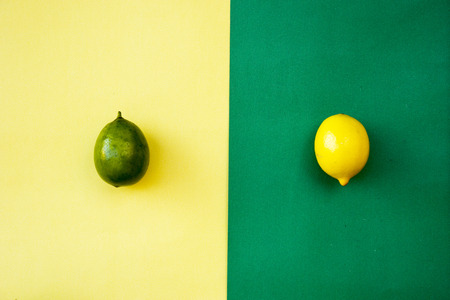 Top view of colorful yellow and green lemons on yellow green pastel background, concepts,summer...