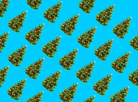 Pattern made of christmas trees on blue background. Christmas concept. Flat lay. Holiday background...