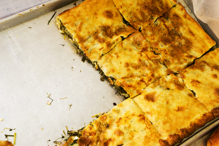 Various puff pastry, flour products pies with herbs on the shelf in the bakery. Baking and bread in the bakery.の写真素材