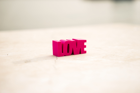 Red word love on a white marble background with copy space.の写真素材
