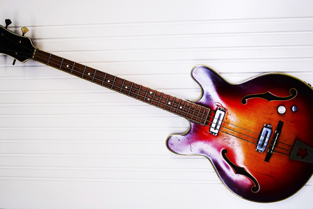 red six-stringed electric guitar isolated on white background