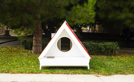 white dog kennel , doghouse stands in the yardの写真素材
