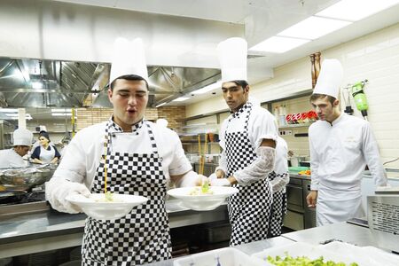 BAKU, AZERBAIJAN, JUNE 20, 2018 : catering, Famous Chef Works in a Big Restaurant Kitchen with His Help. Kitchen is Full of Food, Vegetables and Boiling Dishesのeditorial素材