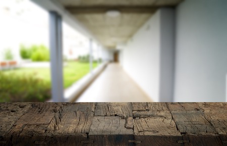Wooden brown table top against the blurred corridor, passage and courtyard of the house .For product display montage or design is the key visual of the layoutの写真素材