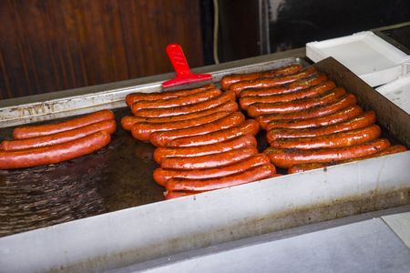 Grill czech sausages on on street food outdoor market. Fried baked sausages. European street food. Street food festivalの写真素材