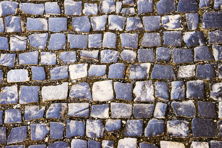 pavement laid out in circles. perspective view. pavement stone gray. stone texture for background. close-up. Abstract cobblestone pavement backgroundの写真素材