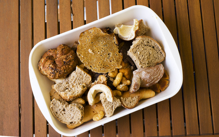Pile of many slices of stale bread and other stale baked goods. Tossing breads and buying too much...
