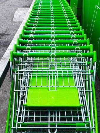 Green shopping carts together in a line up.の写真素材