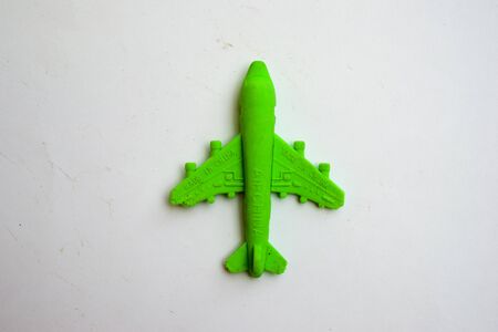 Children toy - green plastic plane with a red propeller, without a pilot, isolated on a white backgroundの写真素材