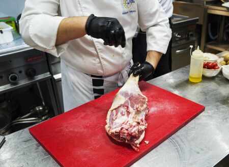 The chef also prepares lamb shank dishes. The process of cooking lamb shank male chef in a...