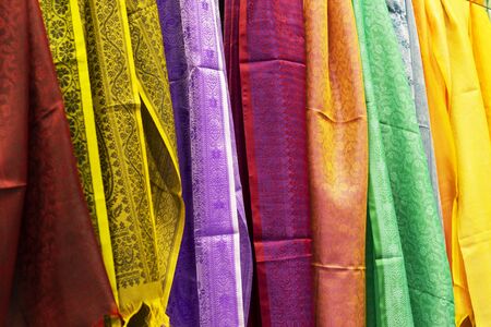 multicolored Indian women's shawls made of silk and cotton in the shop windowの写真素材
