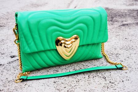 green women's bag made of genuine leather stands on the concrete floorの写真素材