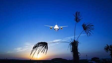 passenger plane fly up over take-off runway from airport at sunset, sunrise.の写真素材