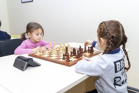 Baku, Azerbaijan, December 10, 2019: little girls play chess at a chess schoolのeditorial素材