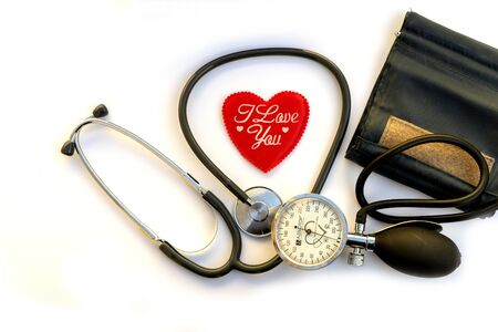 Mechanical pressure measuring device, red heart on white background . Concept healthcare. Cardiology...