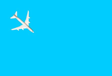 White model of passenger plane on blue background.の写真素材