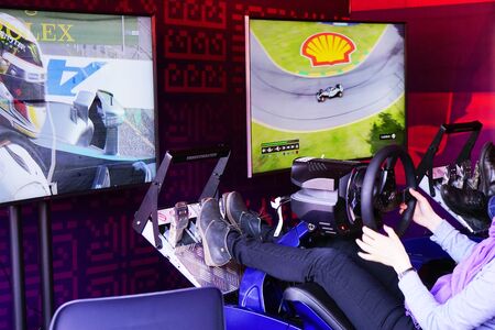 BAKU, AZERBAIJAN - MAY 17, 2016: Public race car Simulator on Ferrari F1 with large audience at Expo Tuning Baku is the premier automotive specialtyのeditorial素材