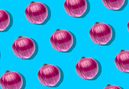 Red whole onion on a blue background.の写真素材