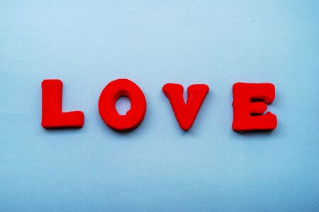 The word Love is made up of red letters on a blue background
