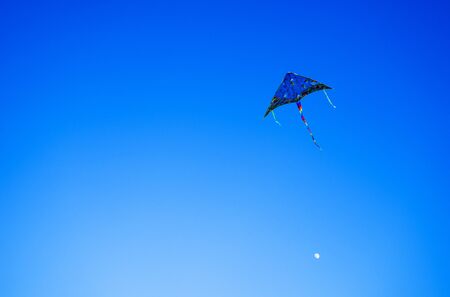 A kite flying in a blue sky.