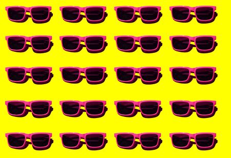 Pink sunglasses pattern on yellow pastel background. Minimal summer concept. Isometric print.の写真素材