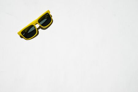 yellow sunglasses pattern on white pastel background. Minimal summer concept. Isometric print.の写真素材