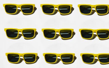 yellow sunglasses pattern on white pastel background. Minimal summer concept. Isometric print.の写真素材