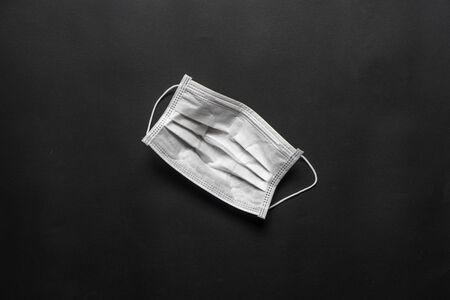 Protect yourself concepts in coronavirus,covid-19 virus outbreak with white mask on black color.body health care.medical equipment.demand and supplyの写真素材