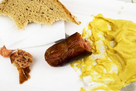 Leftover food, Czech sausages, mustard, bread on the table.の写真素材