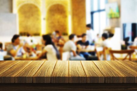 Empty, brown Wood table top Bar with blur light bokeh cafe,restaurant background .Lifestyle and celebration concepts ideasの写真素材