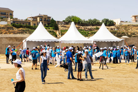 BAKU, AZERBAIJAN- 24 SEPTEMBER 2018: Group of young students helping one another to clean up the beach, safe ecology concepts.のeditorial素材
