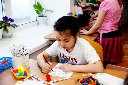 MOSCOW, RUSSIA-APRIL 17, 2014: children play with toys and engage with the tutor in a kindergarten.close upのeditorial素材