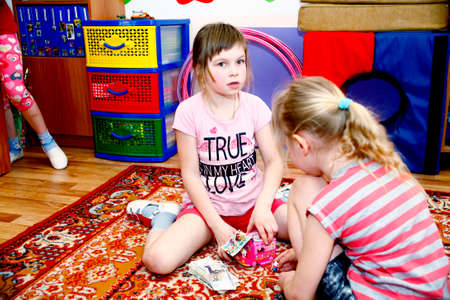 MOSCOW, RUSSIA-APRIL 17, 2014: children play with toys and engage with the tutor in a kindergarten.close upのeditorial素材
