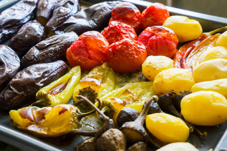Grilled vegetables, roasted slices of potatoes, eggplants and zucchini, vegetarian and vegan dish, close upの写真素材