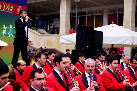 BAKU, Azerbaijan-JUNE 26, 2018: Musicians in red suits play at a street concertのeditorial素材