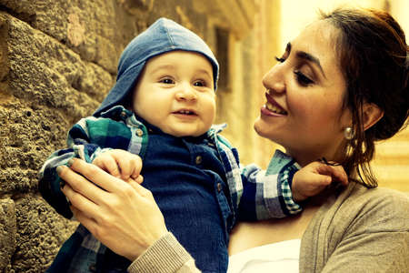 Portrait of happy loving mother and her baby outdoors