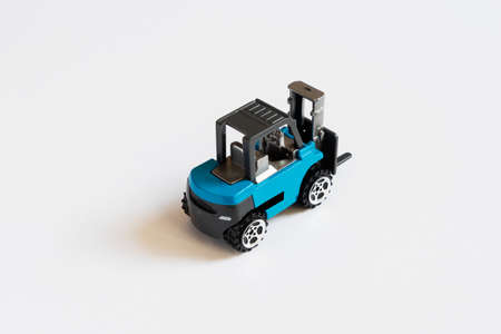 Fork lift truck toy on the white background.