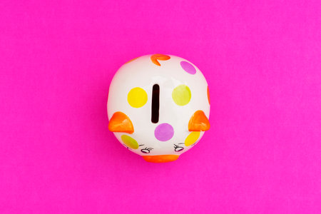 Piggybank on a red background. to save, saving money for affordable things, financial concept .Piggybank or deposit box on a wood background, depict saving money to make a trust fund for children, teach them for saving habitの写真素材