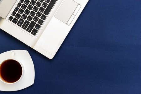 Modern workplace, laptop and accessories on a blue background top viewの写真素材