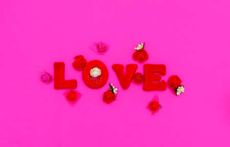 The word Love is made up of red letters on a pink background. Valentine's Day lovers concept.の写真素材