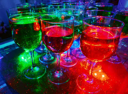 Closeup of multicolored sparking water, stripes pattern of soda pop drinking glasses for party.の写真素材