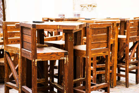 Empty Wooden tables and chairs in a cafe on the street in Prague, Czech Republicの写真素材