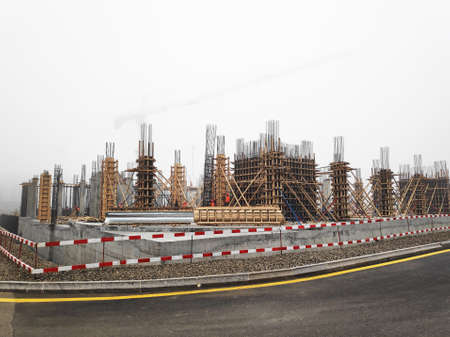 unfinished construction building process with high crane object near urban scene in the city in...