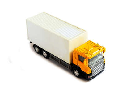 A yellow semi truck with a white trailer attached. Isolated on a white background.の写真素材