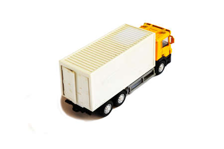 A yellow semi truck with a white trailer attached. Isolated on a white background.の写真素材