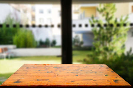 Wooden brown table top against the blurred corridor, passage and courtyard of the house .For product display montage or design is the key visual of the layout.の写真素材