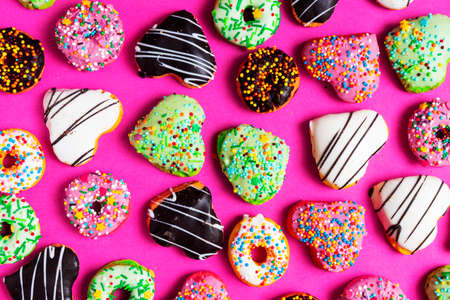 Set of various colorful donuts isolated on pink background. Top view.の写真素材