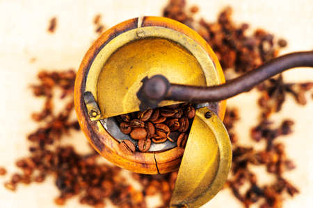 Vintage coffee grinder and coffee beans on a white background.の写真素材
